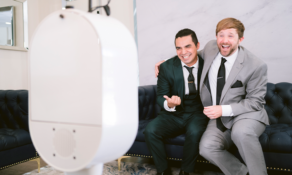 Two groomsmen enjoying a photo booth at a wedding in Monona WI